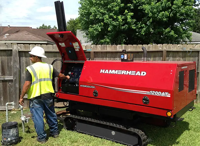 Technicians performing trenchless water line replacement for a Seattle home to preserve the lawn.