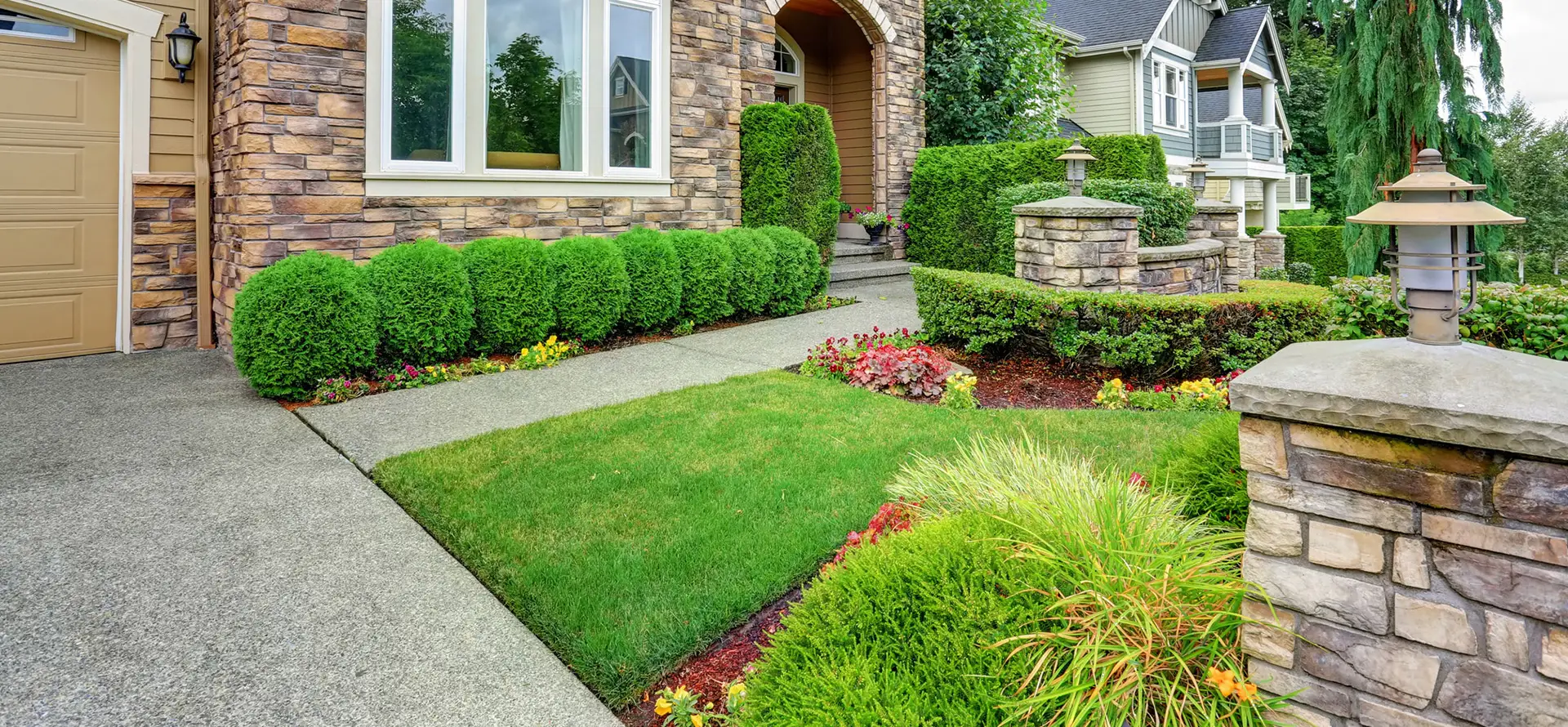 A beautifully landscaped lawn outside a stone exterior home in Seattle's Queen Anne neighborhood, just after Akers detected the family's water leak.